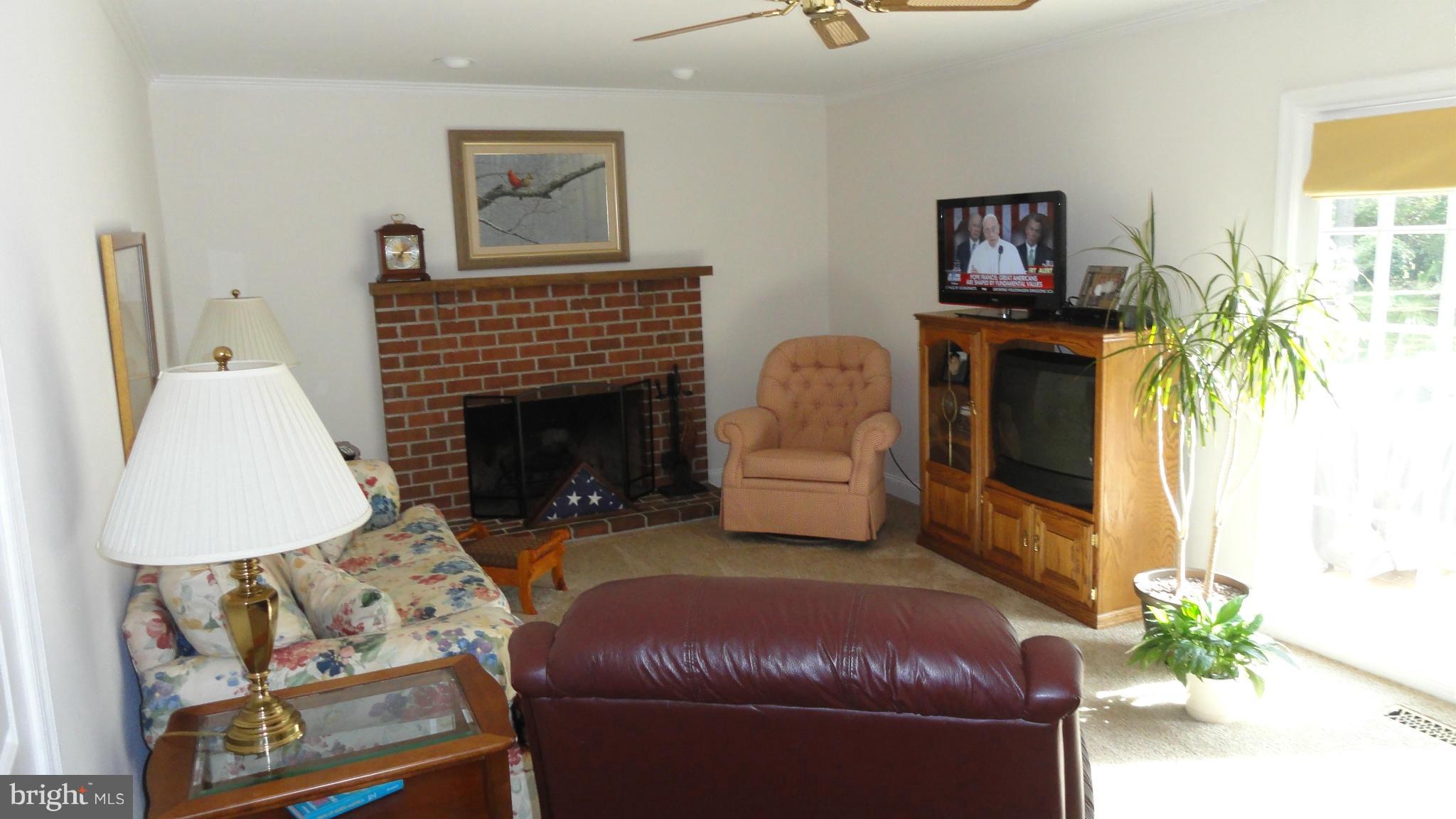 301 Carriage Run Road Annapolis, MD 21403 - Photo 8 of 26 a living room with furniture and a fireplace