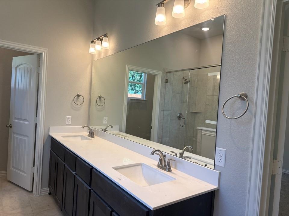 404 Guadalupe Lane Springtown, TX 76082 - Photo 8 of 9 a bathroom with a sink double vanity and a mirror