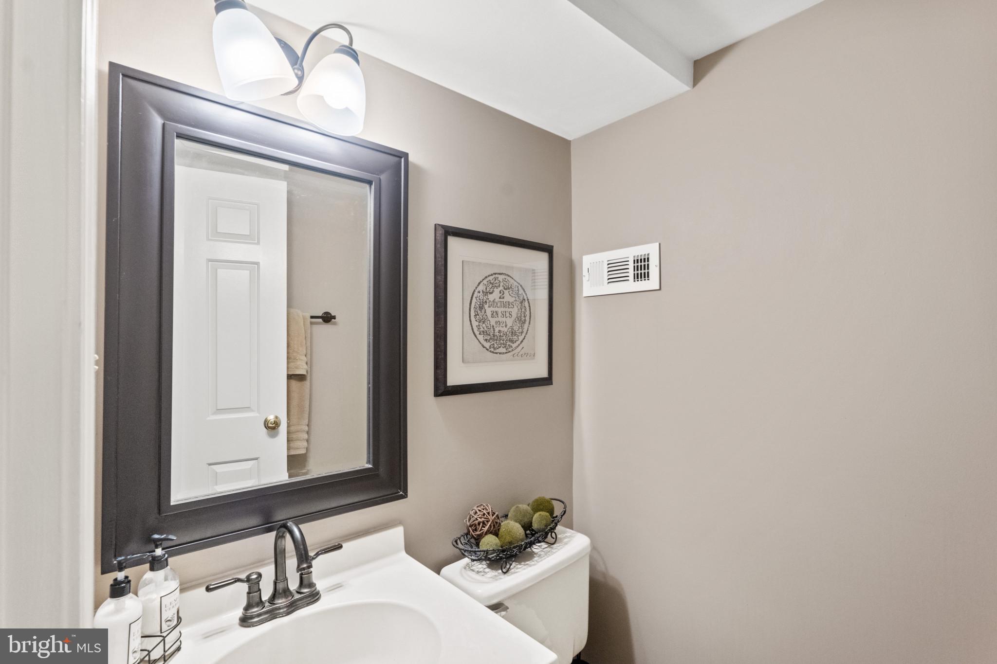 8024 Hollow Reed Court Frederick, MD 21701 - Photo 22 of 25 a bathroom with a toilet sink and mirror