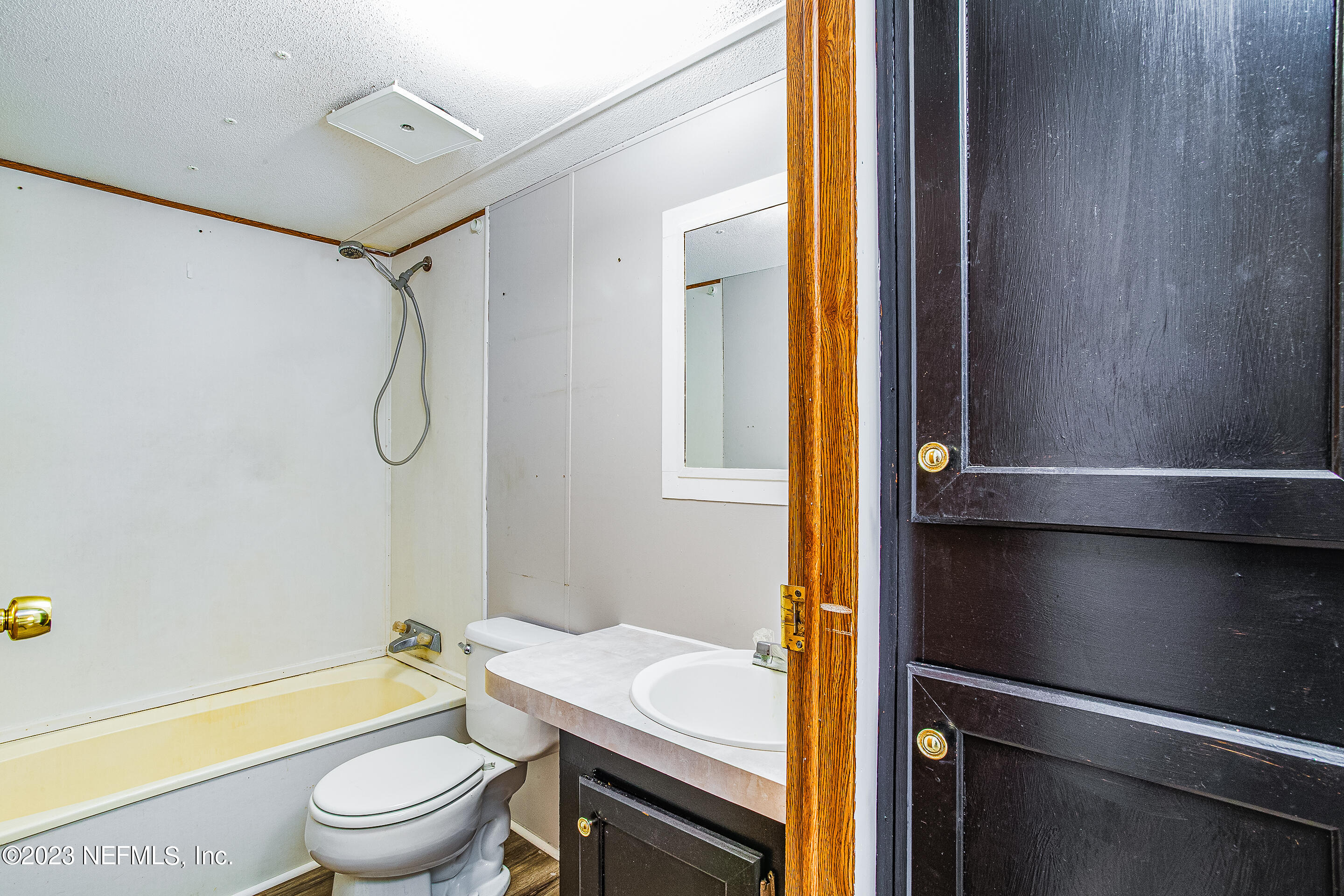 35157 Goodbread Road Callahan, FL 32011 - Photo 13 of 38 a bathroom with a granite countertop sink toilet and shower