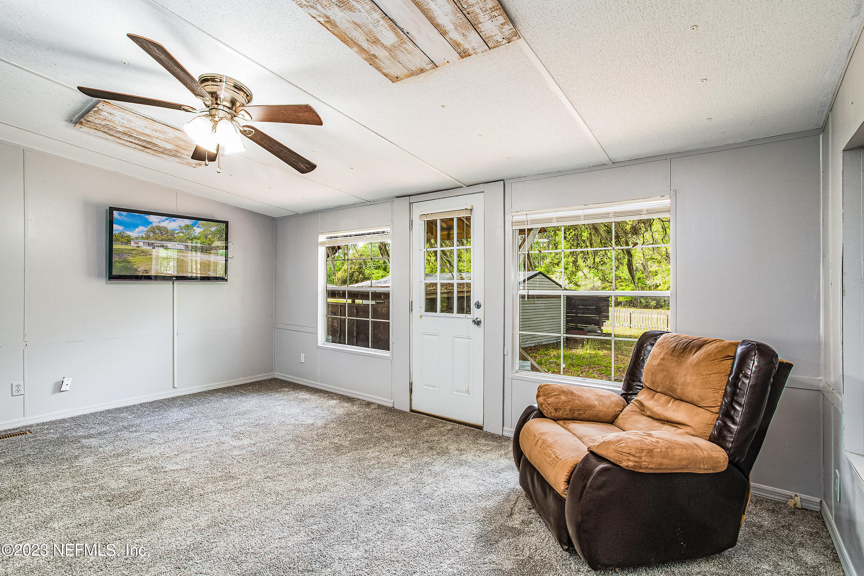 35157 Goodbread Road Callahan, FL 32011 - Photo 18 of 38 a living room with furniture and a large window