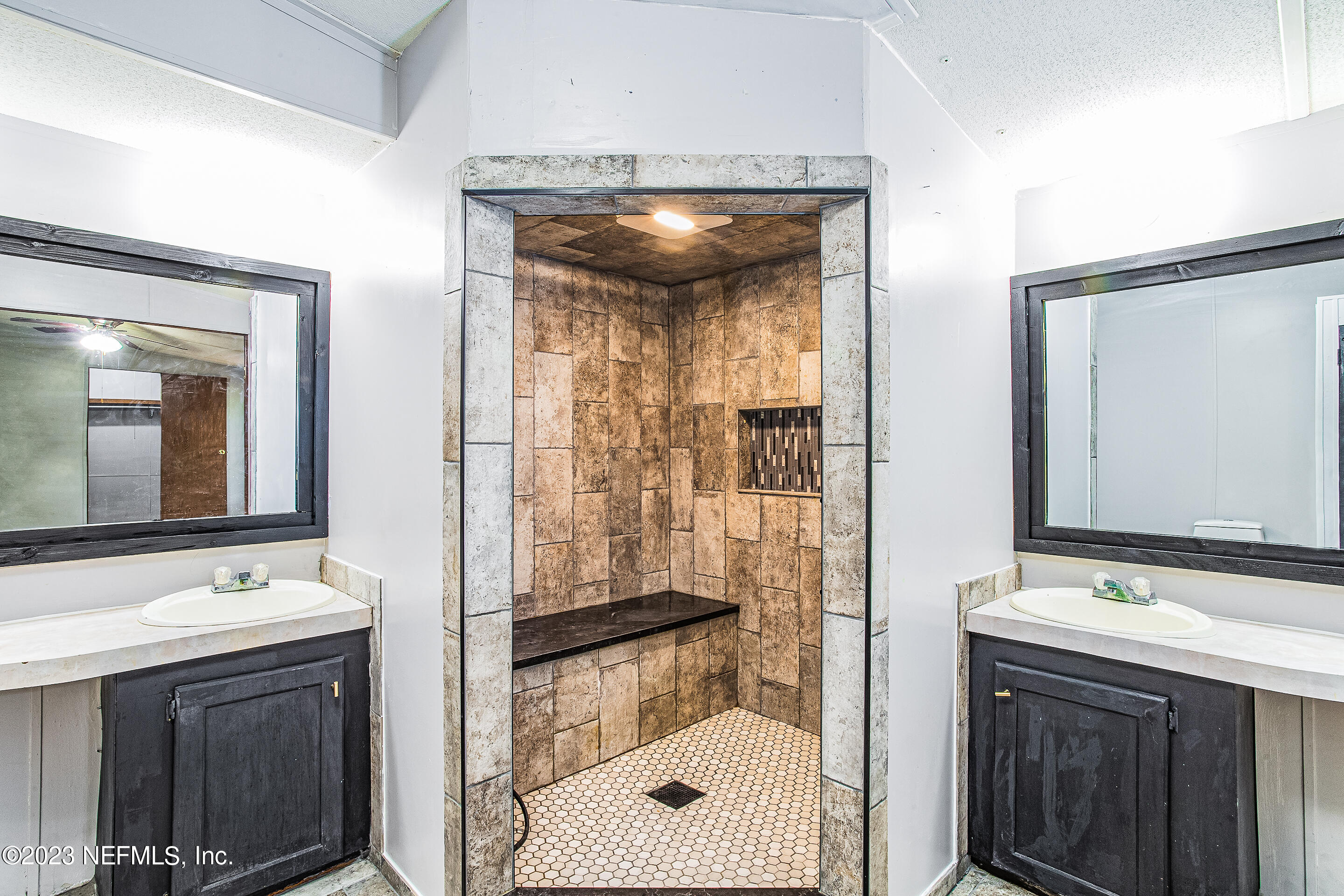 35157 Goodbread Road Callahan, FL 32011 - Photo 22 of 38 a bathroom with a sink a mirror and a shower