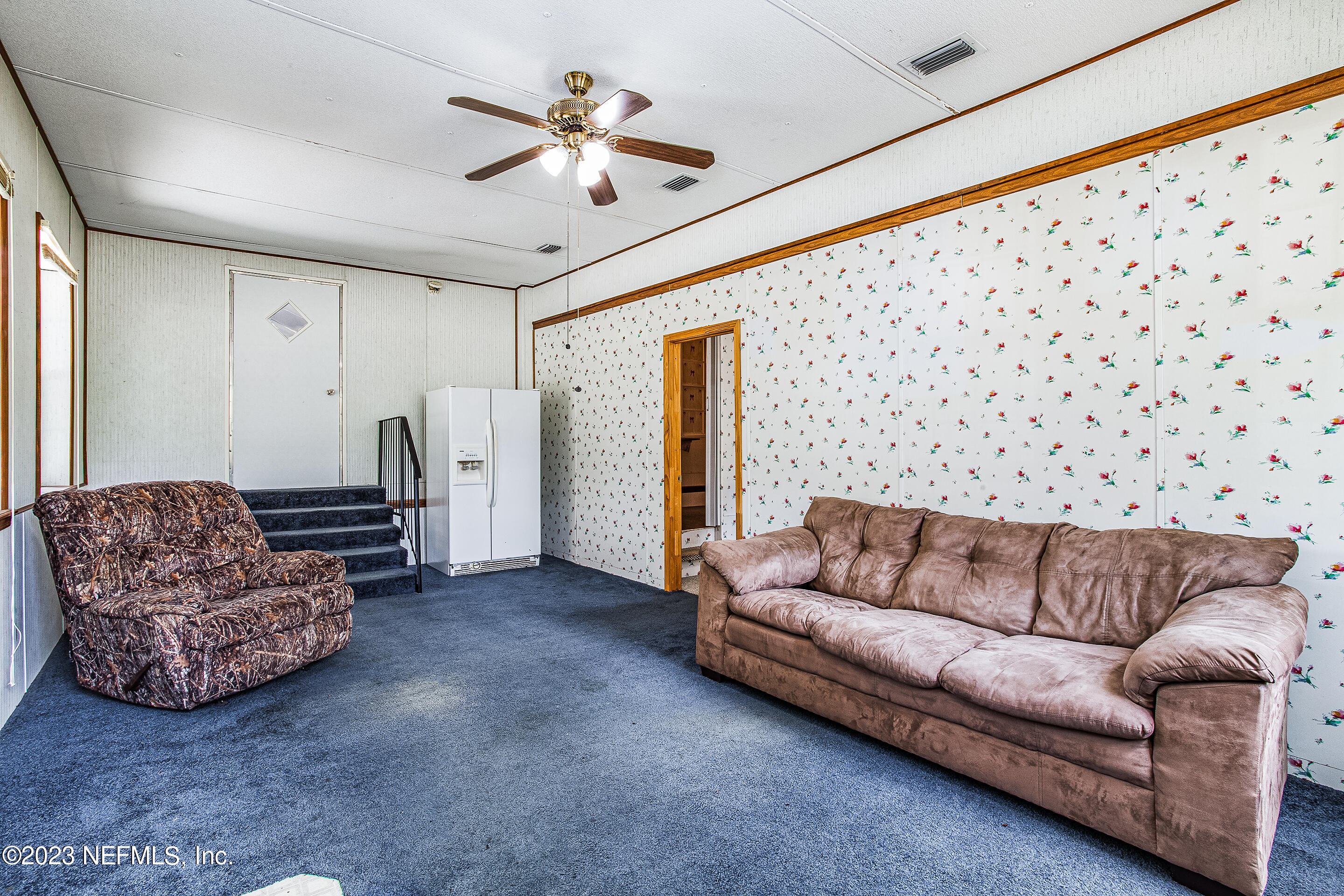 35157 Goodbread Road Callahan, FL 32011 - Photo 26 of 38 a living room with furniture and a chandelier