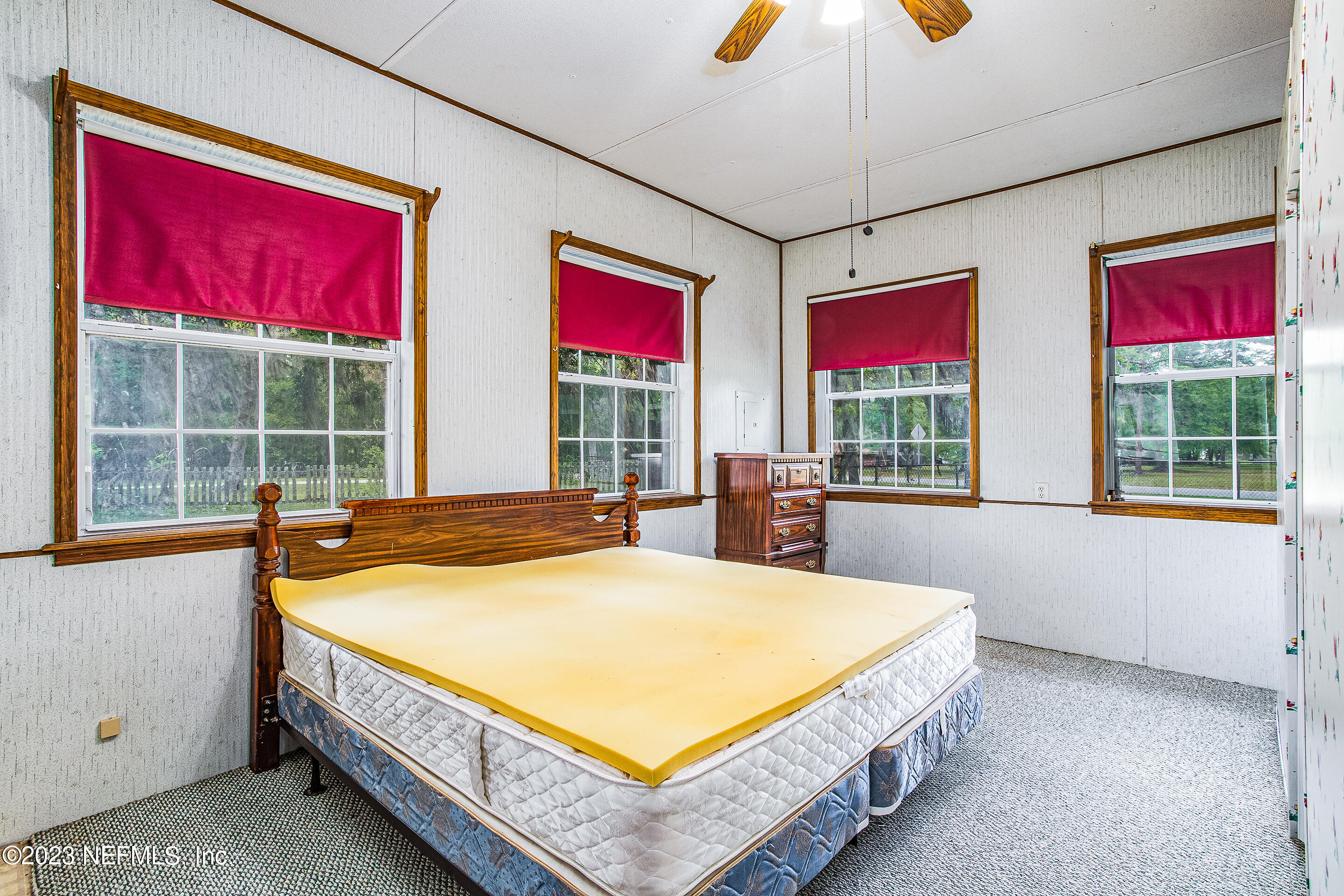 35157 Goodbread Road Callahan, FL 32011 - Photo 28 of 38 a spacious bedroom with a large bed and a chandelier