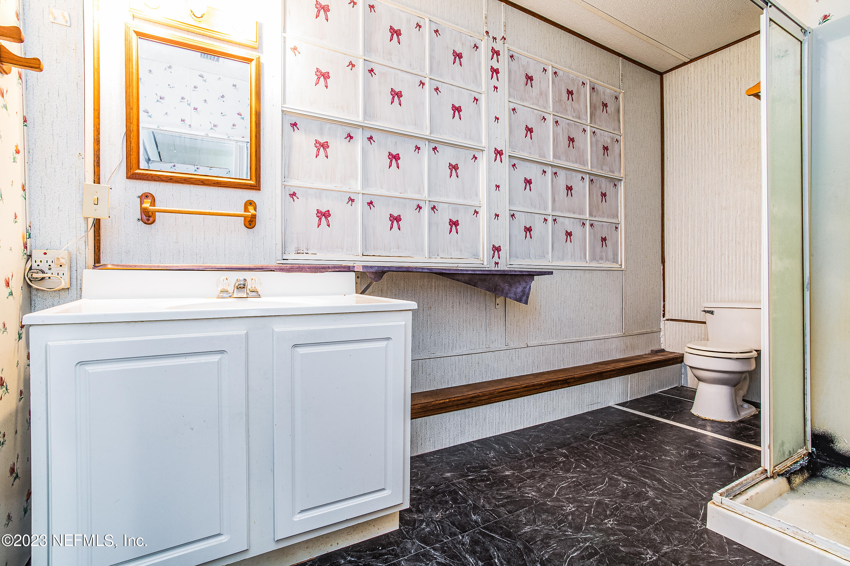 35157 Goodbread Road Callahan, FL 32011 - Photo 30 of 38 a bathroom with a sink a toilet and a mirror