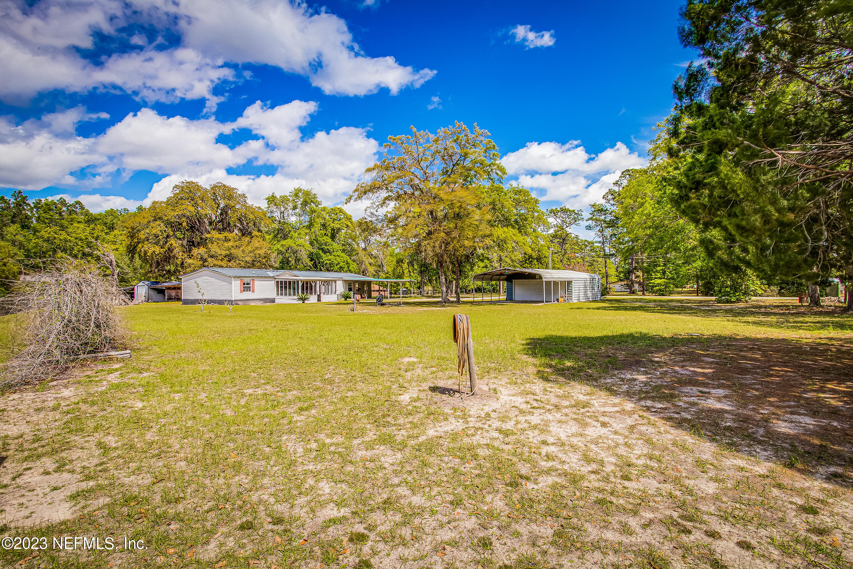 35157 Goodbread Road Callahan, FL 32011 - Photo 31 of 38 a view of a swimming pool with an outdoor space and seating area