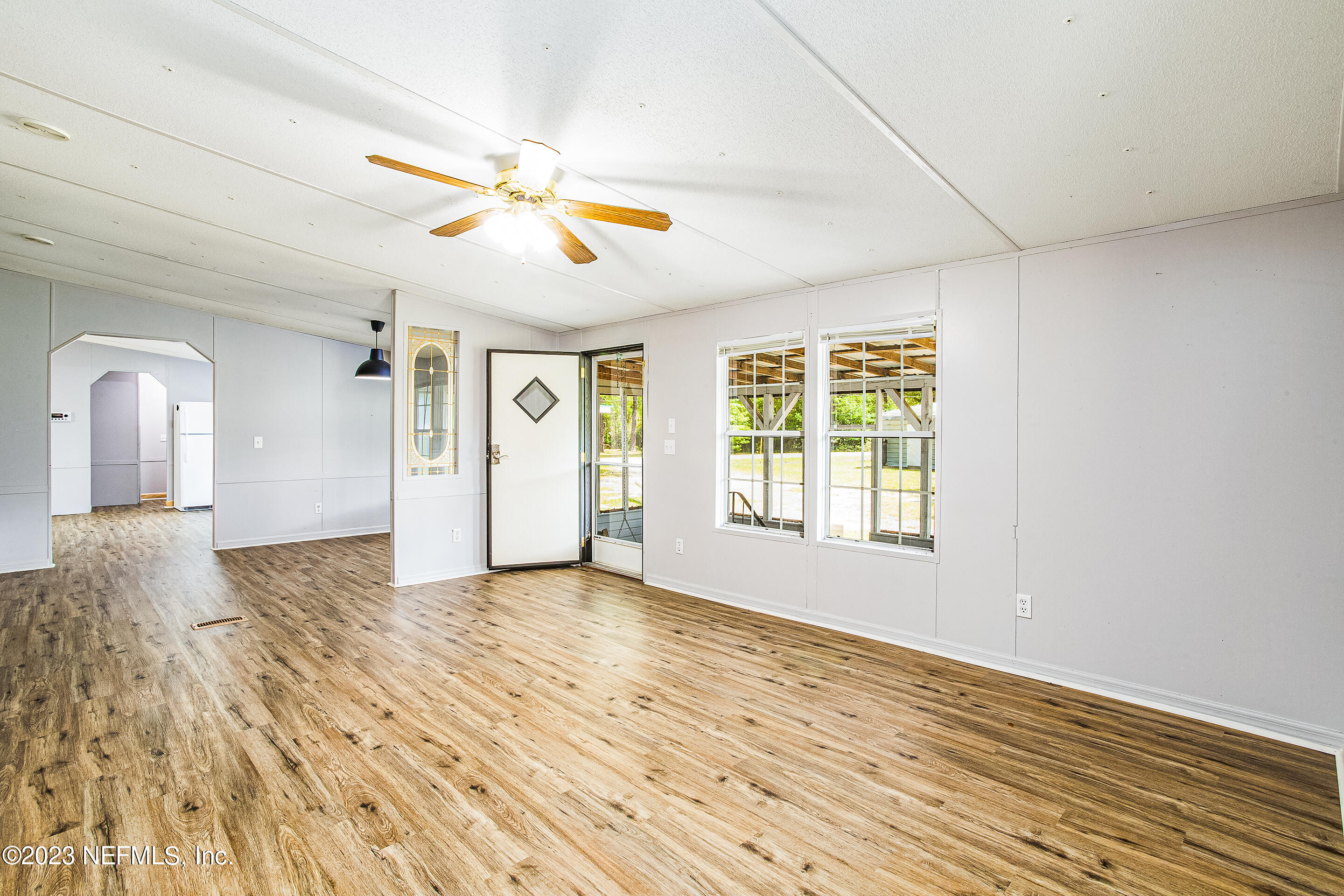 35157 Goodbread Road Callahan, FL 32011 - Photo 8 of 38 a view of empty room with wooden floor and fan