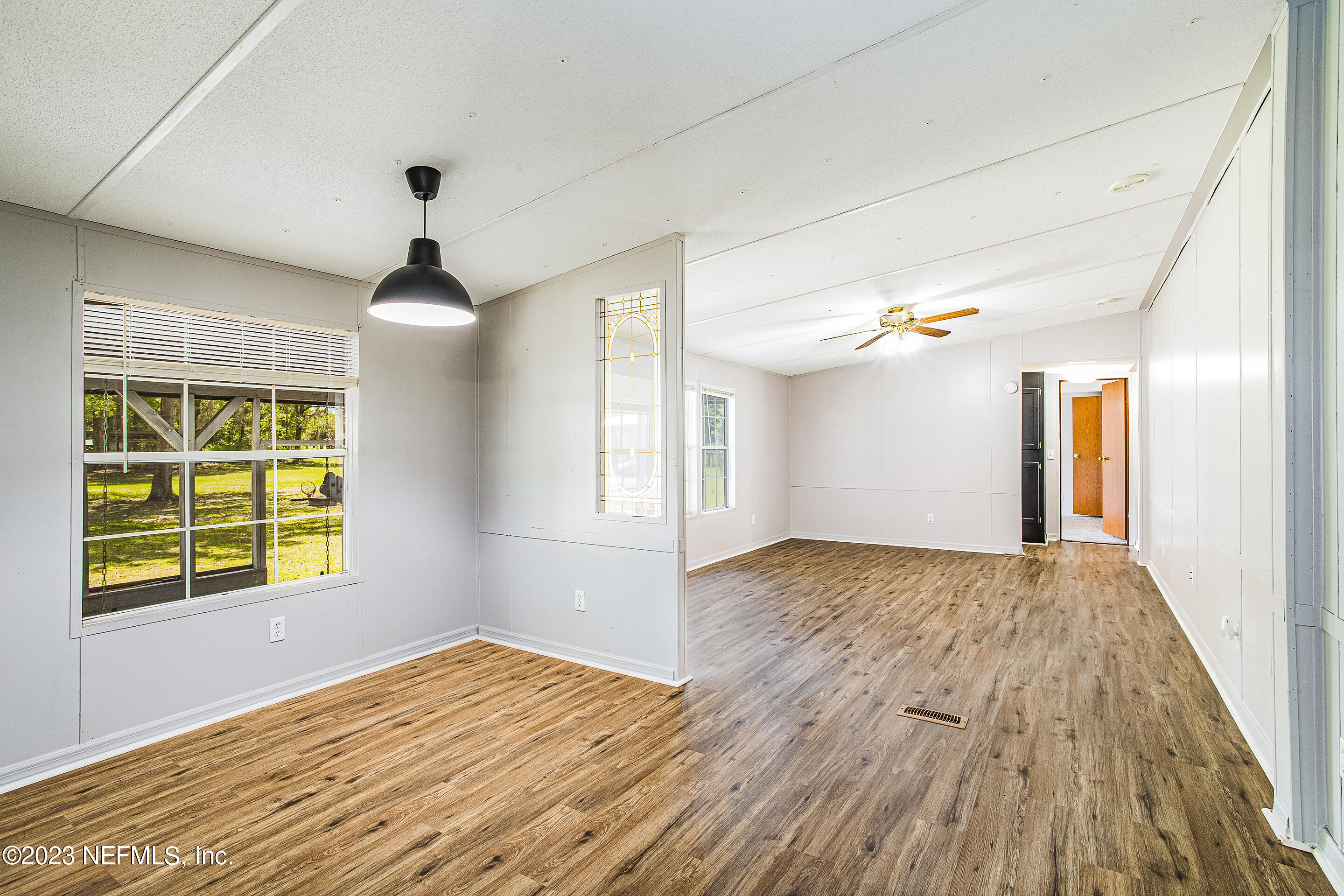 35157 Goodbread Road Callahan, FL 32011 - Photo 9 of 38 a view of empty room with wooden floor and fan