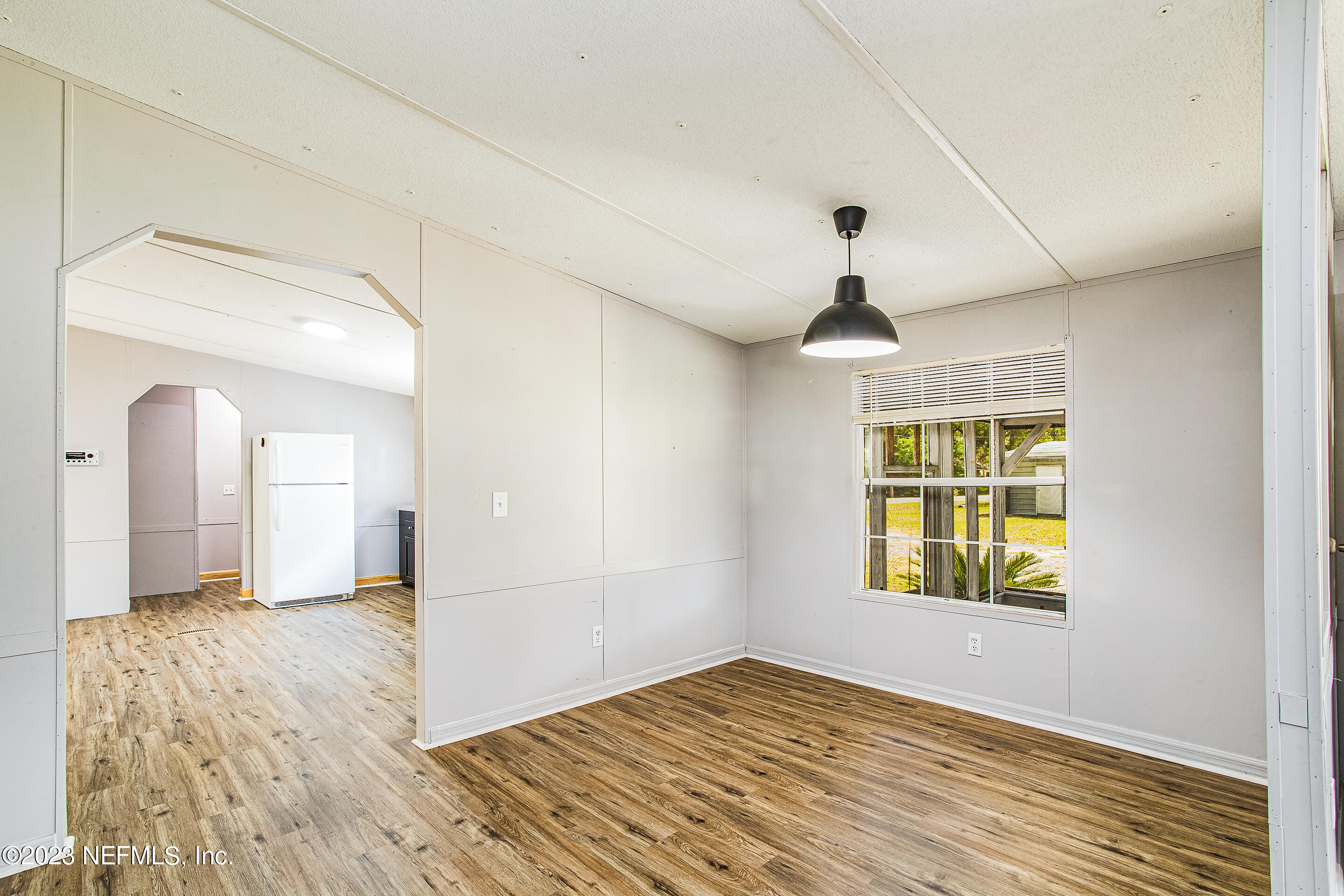 35157 Goodbread Road Callahan, FL 32011 - Photo 10 of 38 a view of an empty room with window and wooden floor