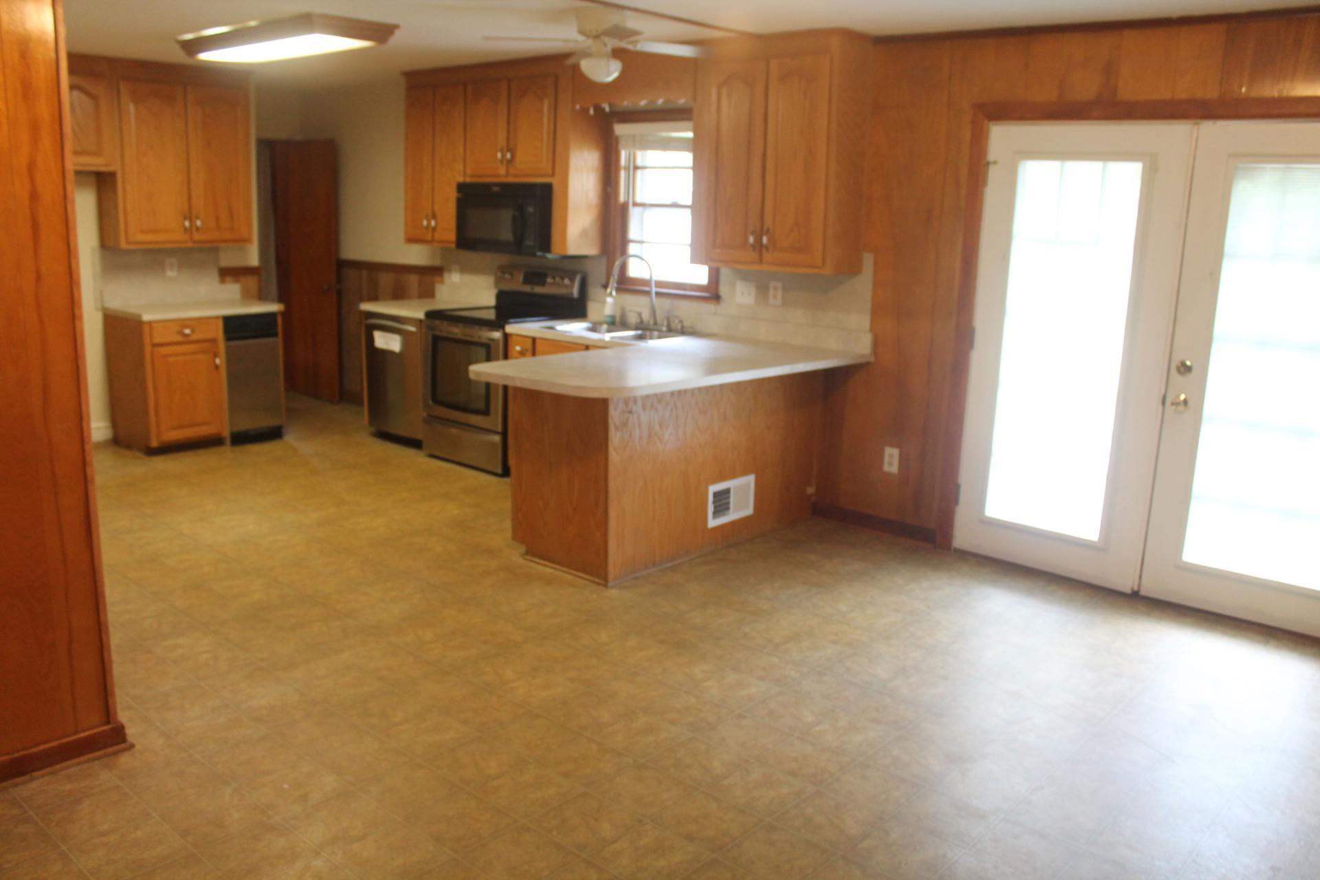 109 Villa Road Ridgeway, VA 24148 - Photo 11 of 32 a kitchen with stainless steel appliances granite countertop a stove a sink and a refrigerator