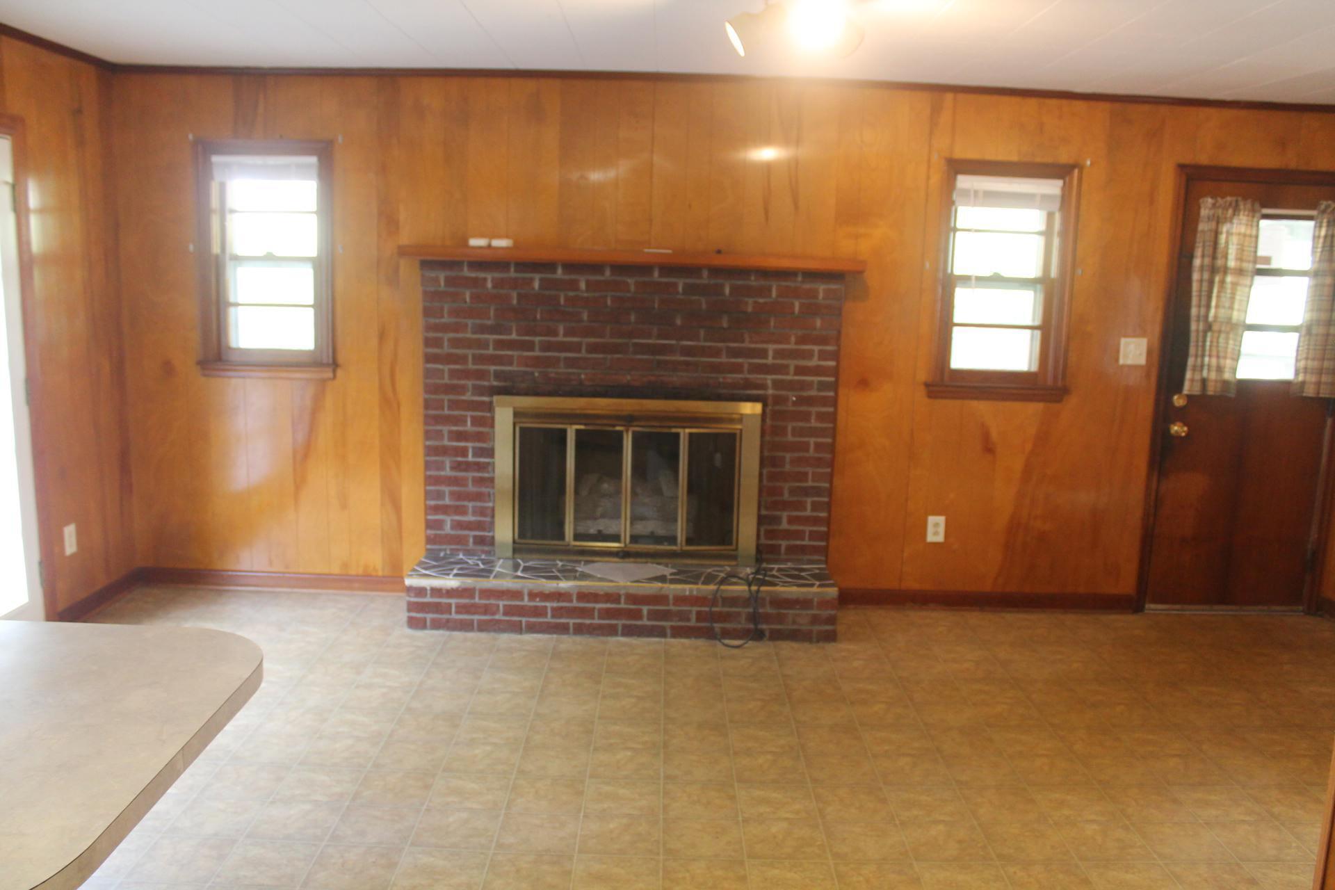 109 Villa Road Ridgeway, VA 24148 - Photo 14 of 32 an empty room with a fireplace