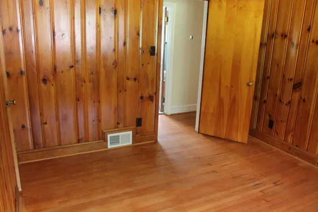 a view of an empty room with wooden walls