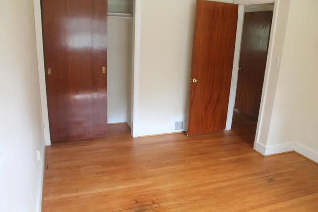 a view of hallway with a bathroom