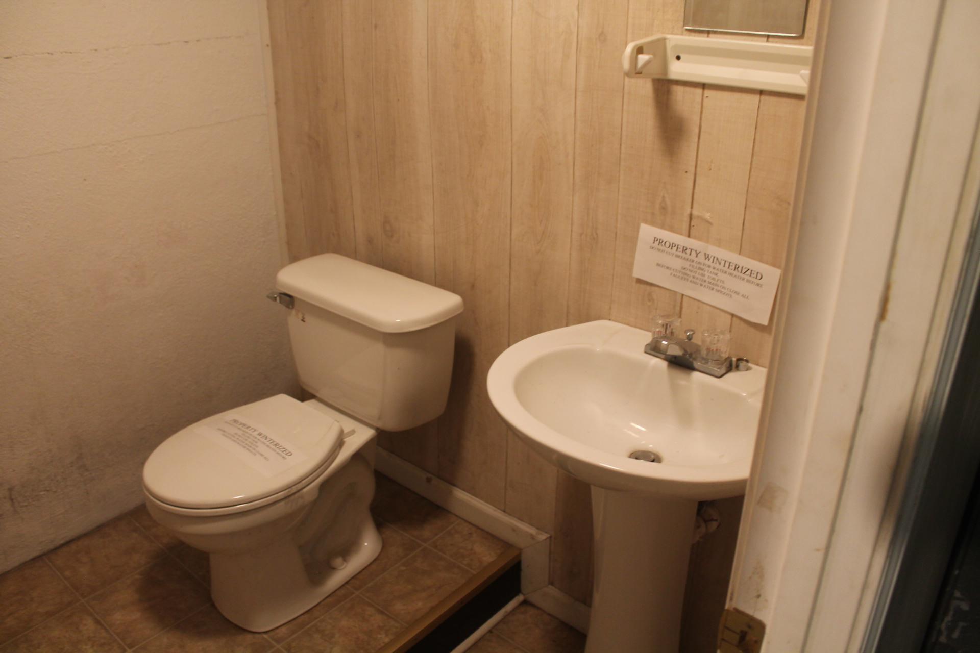 109 Villa Road Ridgeway, VA 24148 - Photo 28 of 32 a white toilet sitting next to a sink