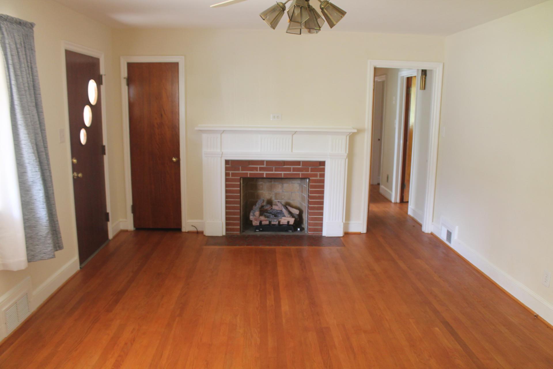 109 Villa Road Ridgeway, VA 24148 - Photo 6 of 32 an empty room with windows and a fireplace