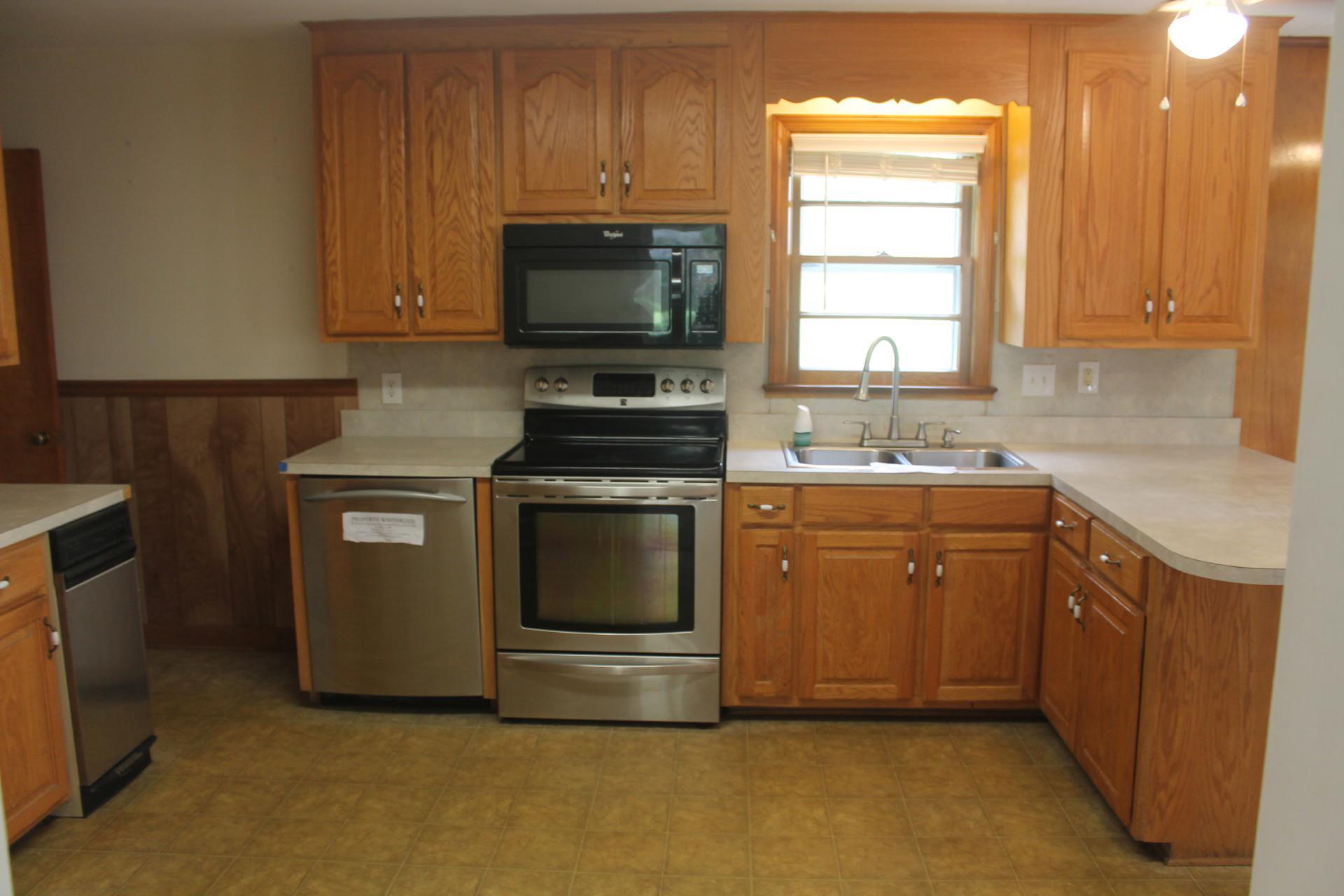 109 Villa Road Ridgeway, VA 24148 - Photo 8 of 32 a kitchen with a sink stove and microwave