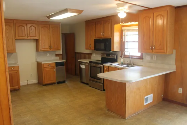 a kitchen that has a sink and a stove in it