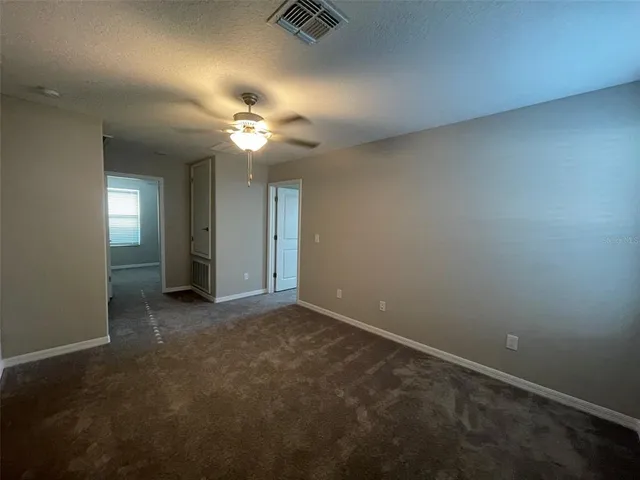 a view of a room with a ceiling fan and chandelier fan