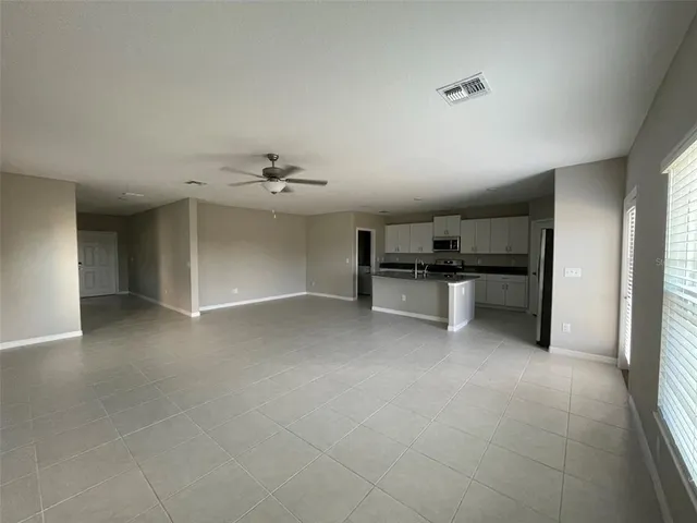 a view of a livingroom with furniture and a kitchen