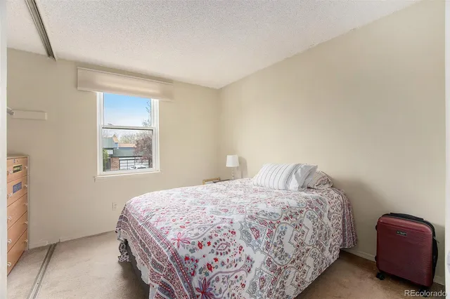 a bedroom with a bed and a chair