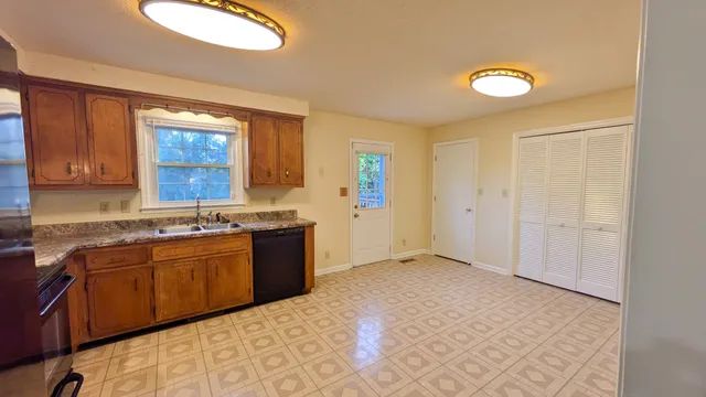 a kitchen with stainless steel appliances granite countertop a sink and cabinets