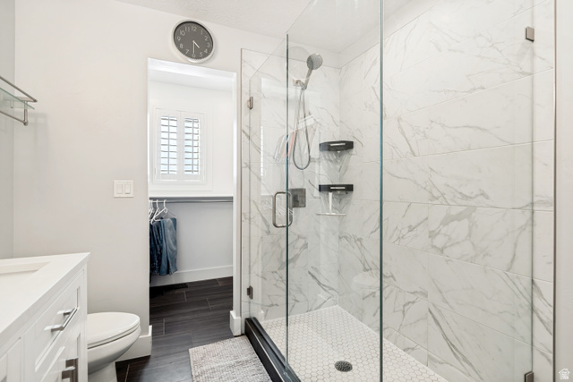 9832 Falconhurst Drive Sandy, UT 84092 - Photo 12 of 29 Glass-enclosed shower featuring white marble-look subway tile and a hexagonal tile floor