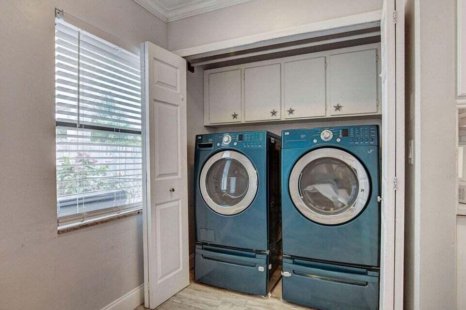 115 Northeast 18th Street Delray Beach, FL 33444 - Photo 12 of 36 a view of storage and utility room with washer and dryer