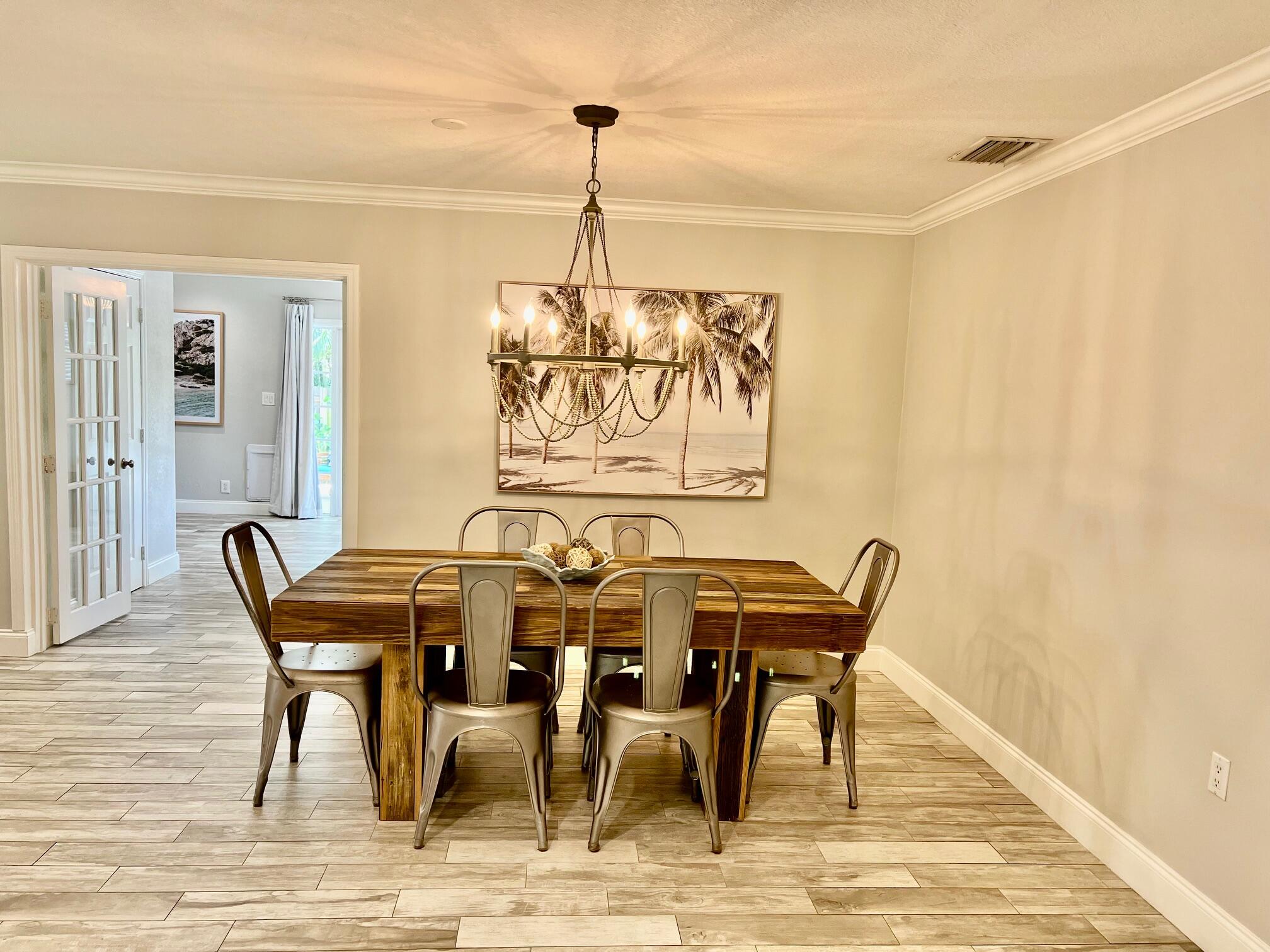 115 Northeast 18th Street Delray Beach, FL 33444 - Photo 13 of 36 a view of a dining room with furniture and wooden floor