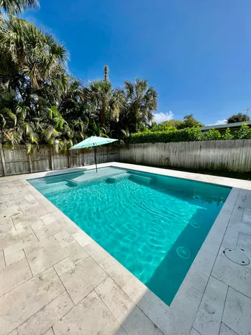 a swimming pool with trees in the background