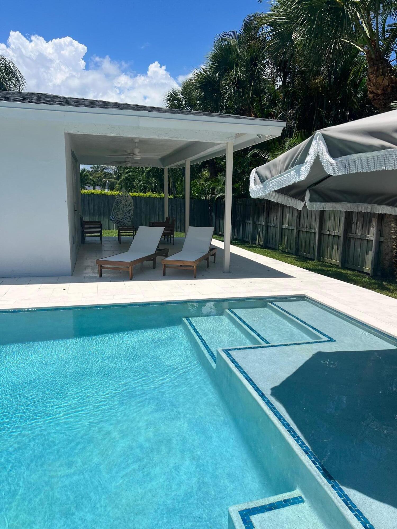 115 Northeast 18th Street Delray Beach, FL 33444 - Photo 26 of 36 a view of a house with a backyard and porch