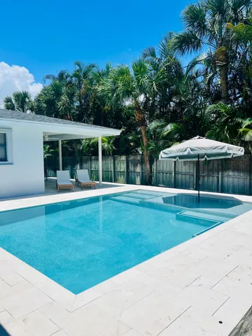 a swimming pool with outdoor seating and yard
