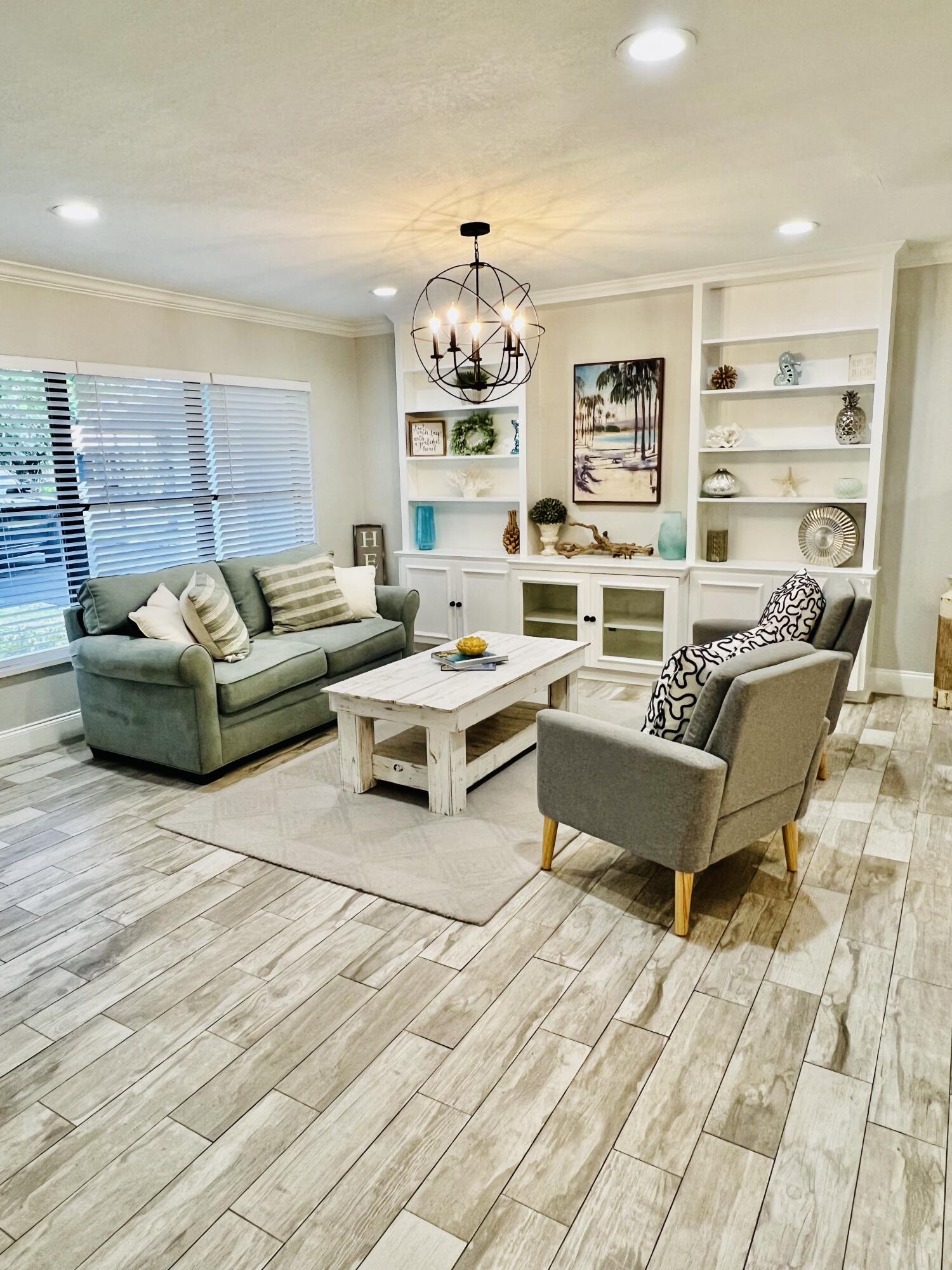 115 Northeast 18th Street Delray Beach, FL 33444 - Photo 5 of 36 a living room with furniture and a chandelier