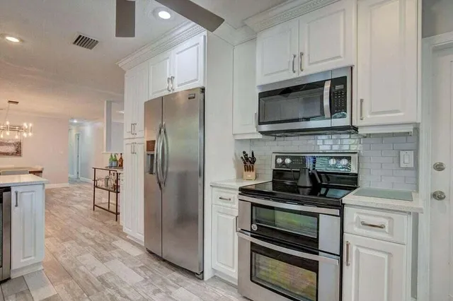 a kitchen with granite countertop a stove and a refrigerator