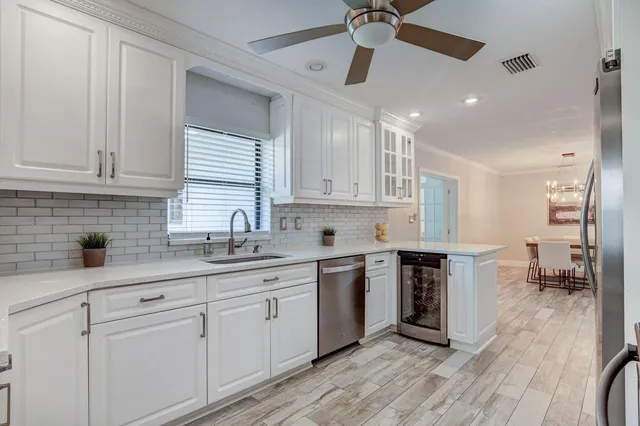 a kitchen with a sink cabinets and window