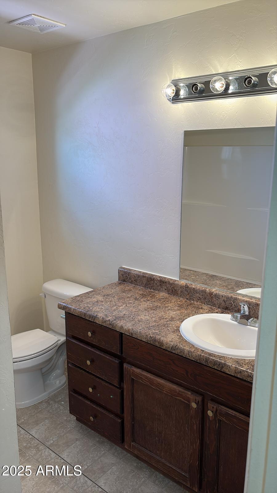 1057 D Avenue Douglas, AZ 85607 - Photo 7 of 8 a bathroom with a granite countertop sink and a mirror