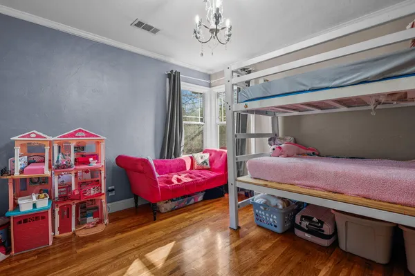 a view of a bedroom with furniture and wooden floor