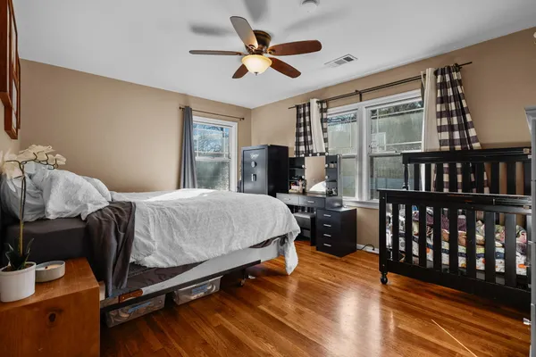 a bedroom with a bed and a chandelier