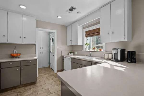 a kitchen with a sink stove and cabinets