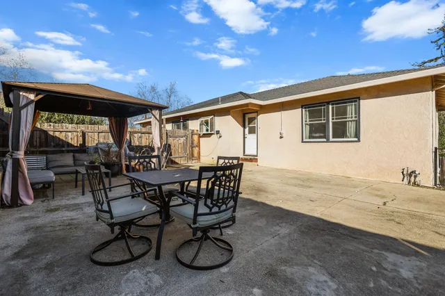 a swimming pool with outdoor seating and yard