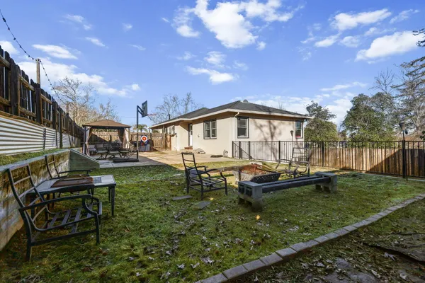 a view of a swimming pool with a patio and a yard