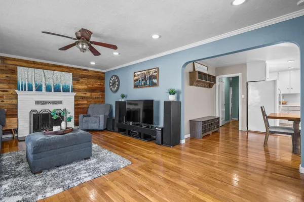a dining room with furniture a chandelier and wooden floor