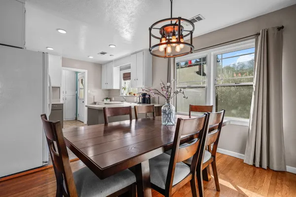 a view of a dining room with furniture and wooden floor