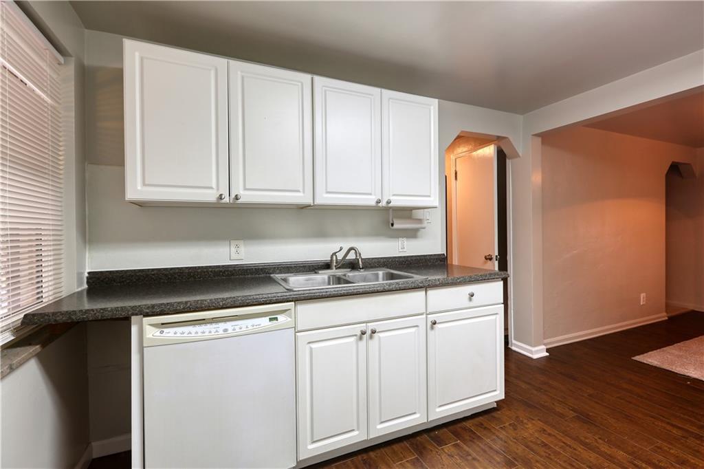 836 Railroad Street McKees Rocks, PA 15136 - Photo 6 of 24 a kitchen with granite countertop white cabinets and a stove top oven