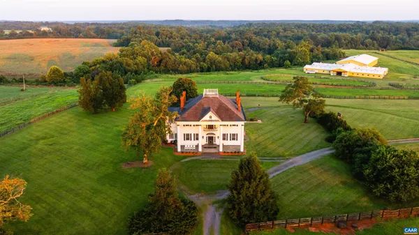 a aerial view of a house with a yard and lake view