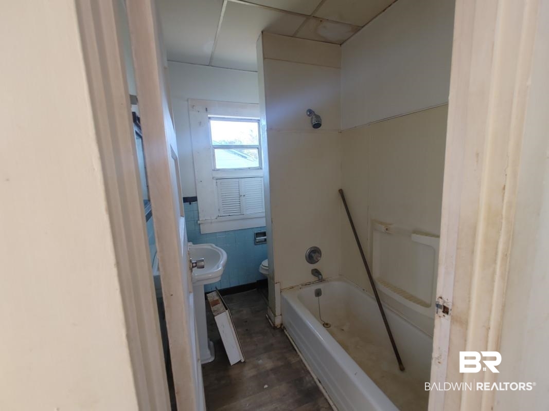 1706 Lomeroy Street Mobile, AL 36604 - Photo 12 of 24 Bathroom with toilet and wood finished floors
