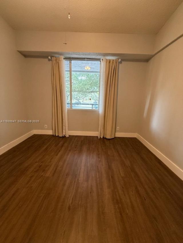 921 Lyons Road, Unit 3205 Coconut Creek, FL 33063 - Photo 11 of 37 wooden floor in an empty room with a window