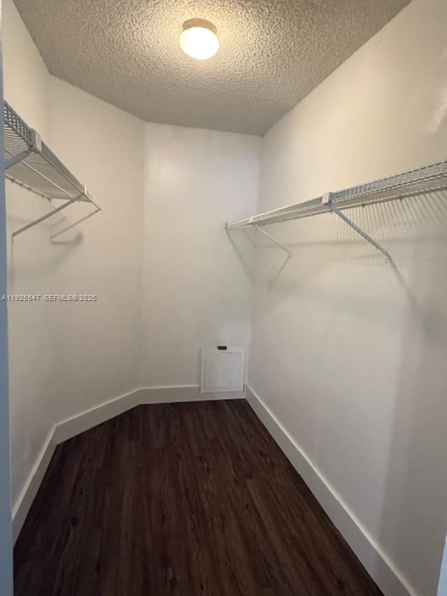 921 Lyons Road, Unit 3205 Coconut Creek, FL 33063 - Photo 13 of 37 a view of a room with wooden floor and cabinets