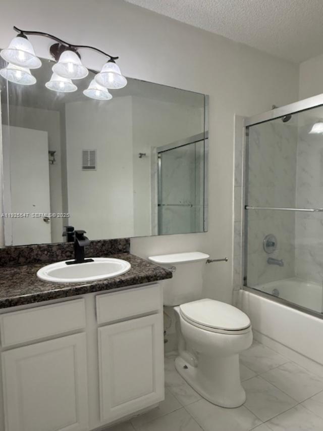 921 Lyons Road, Unit 3205 Coconut Creek, FL 33063 - Photo 14 of 37 a bathroom with a granite countertop sink a toilet a mirror and shower