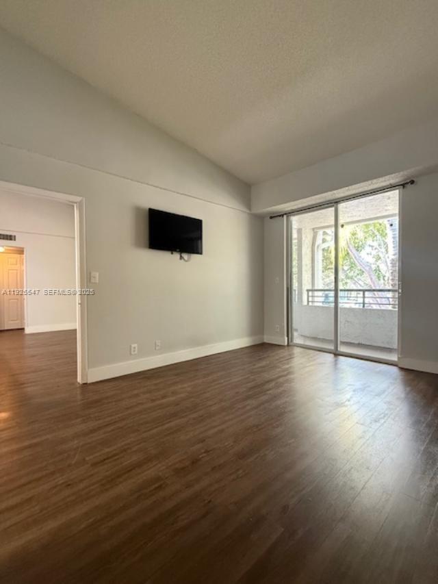 921 Lyons Road, Unit 3205 Coconut Creek, FL 33063 - Photo 17 of 37 an empty room with wooden floor and windows