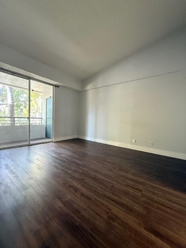 921 Lyons Road, Unit 3205 Coconut Creek, FL 33063 - Photo 18 of 37 an empty room with wooden floor and windows